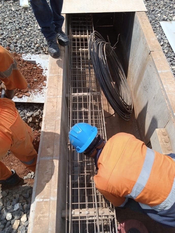 Workers installing underground power cables
